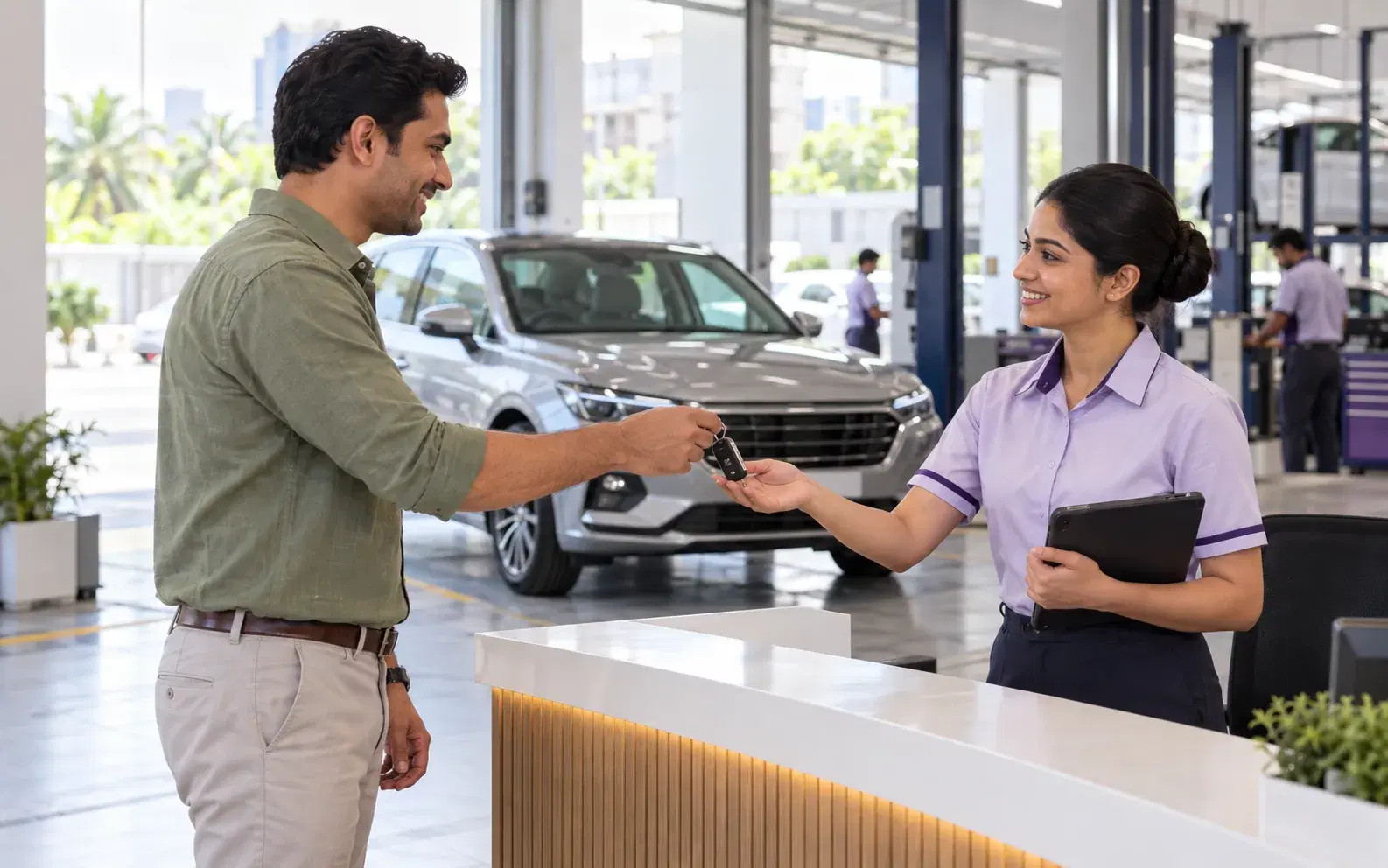 A customer handing car keys to a service advisor at a workshop reception